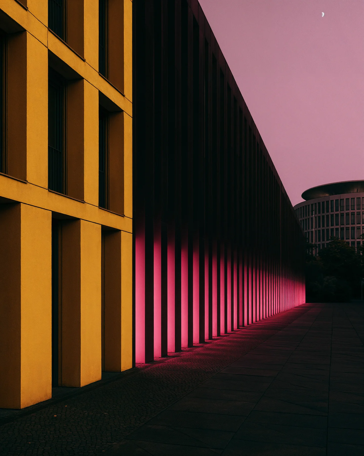 Yellow architecture fading into deep shadow and pink light.